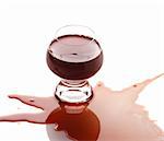 The spilled red wine. Wine poured on a surface, is isolated on a white background