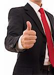 A business man giving the thumb-up sign (focus on the hand)