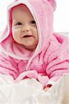 Smiling baby in pink hooded bathgown