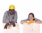 Young african american carpenter and woman carpenter holding wooden plank