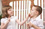 Sister and Brother Having Fun Eating an Apple