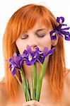 Close-up of beautiful young model with closed eyes and purple flower
