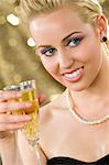 A beautiful young woman with bright blue eyes enjoying a glass of champagne.