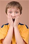 Surprised boy portrait isolated on beige background