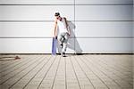 skater holding his skateboard while taking a break