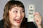 Woman with hand of money, looking Ecstatic with herself on a Black background.