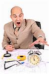 businessman looking at clock alarm at a desk