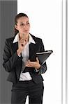 beautiful businesswoman with file and pen before window