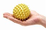 Woman presenting a yellow massage ball. Isolated on a white background.