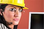 A businesswoman headphone and helmet in office