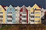 Colorful houses (swedish style) in red, blue and yellow with dark sky