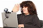 boy using laptop, waving hand of a webcam