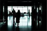 people silhouettes walking in an airport