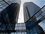 Two inter-reflected Frankfurt’s buildings on morning sky background