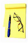 A yellow notepad glasses and a pen isolated against a white background