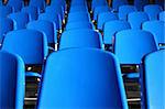 Several rows of blue plastic stadium seats
