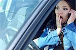angry woman with mobile phone in her car