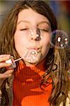 The young girl inflates soap bubbles