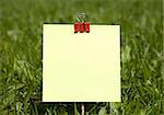 Yellow Note On Green Grass Background