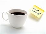 A cup of fresh coffee and a yellow note with this text: 'Good morning!'