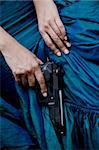 close up photo of female assassin wearing blue gown