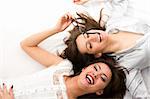 Close- up.Two smiling businesswomen have fun lying on the floor