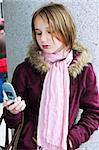 Teenage girl text messaging on cell phone