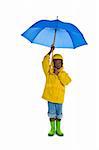 A young African American boy wearing a yellow rain slicker and carrying a blue umbrella. Isolated on a white background.