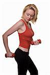 Attractive blond hair woman in red and black workout attire holding two hand weights doing arm exercises with serious expression  standing over white