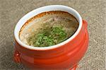 soup served in a ceramics pot, shallow DOF