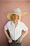 Senior Citizen Man Wearing a Straw Cowboy Hat Looks Off