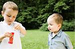 Two Young Brothers Playing Outdoors