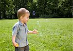 Little Boy Blowing Soap Bubbles