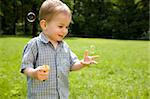 Laughing Kid Catches Soap Bubbles