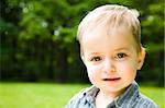 Little Smiling Baby On Natural Background