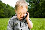 Baby Boy Speaking By Phone Outdoors