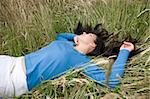 attractive brunette woman relaxing on  meadow