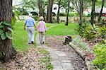 Senior couple strolling down a garden path together.  A metaphore for life's journey.