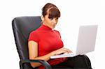 Businesswoman working on her laptop while sitting on chair