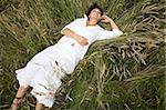 attractive brunette woman lying on meadow