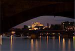 city centre of Prague by night - observed through a bridge arch