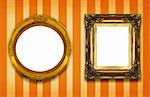 two hollow gilded frames on striped background