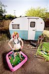 Woman standing in a play pool outside a trailer