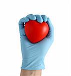 hand in latex blue gloves holding a toy heart isolated in white