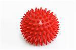 Red massage ball on bright background