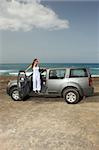 Woman and her 4wd car at the beach