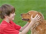 Boy Playing with His Golden Retriever