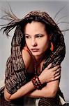 Portrait of young fashion woman with brown accessories and scarf