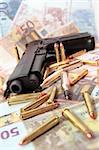 gun bullets and money showing a dangerous side to life