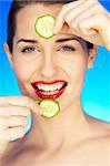 Portrait of beautiful woman with cucumber slice